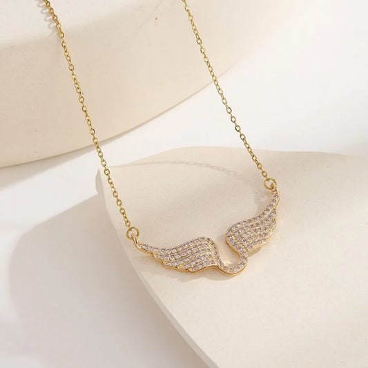 Gold necklace with a wavy design on a white background